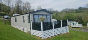 a tiny house in a yard on a grass field at The Key is Under the Mat in Polperro