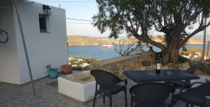 a table and chairs with a view of the water at ΜaryAnn`s house 2 in Livadakia