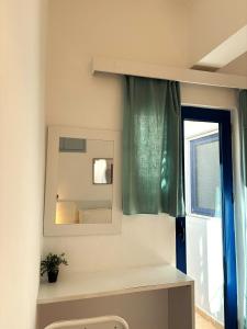 a bathroom with a mirror and a sink at Maria Mare in Myrtos