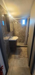 a bathroom with a sink and a shower at ΜaryAnn`s house 2 in Livadakia +12 photos