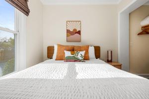 a bedroom with a white bed and a window at Newly Renovated Steps to Bars & Restaurants in Charleston
