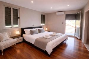 a bedroom with a large bed and a chair at Kuća za odmor ANTON in Blato +40 photos