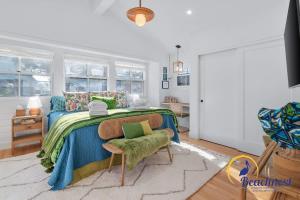 a bedroom with a large bed with a blue blanket at Tiki Tides in Rio Del Mar