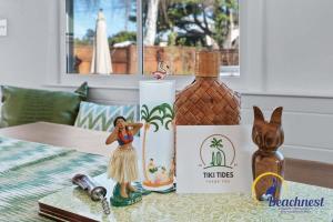 a table topped with a figurine next to a bottle of alcohol at Tiki Tides in Rio Del Mar