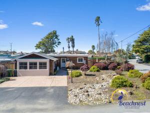 a home with a driveway and a house at Tiki Tides in Rio Del Mar
