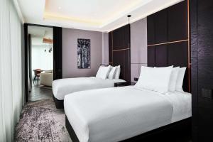 a hotel room with two beds and a mirror at Hilton Belgrade in Belgrade +97 photos