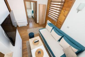 a living room with a couch and a table at Apartmani Dino Kolasin in Kolašin