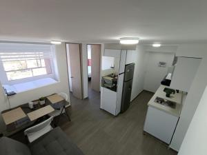a small room with a kitchen and a table at Penthouse Barú - Usaquén in Bogotá +8 photos