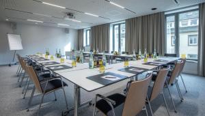 a conference room with a long table and chairs at Hilton Garden Inn Mannheim in Mannheim