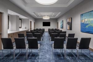 a conference room with chairs and a screen at Hampton Inn Boston Woburn in Woburn +21 photos