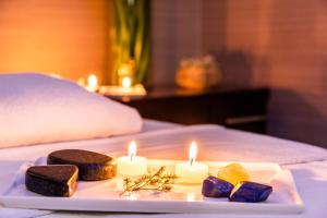 a plate with candles and cookies on a bed at Hilton DoubleTree Bogotá Salitre AR in Bogotá