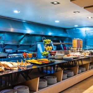 a buffet in a restaurant with food on display at Hilton DoubleTree Bogotá Salitre AR in Bogotá