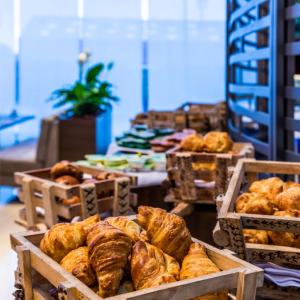 a display of breads and pastries in wooden baskets at Hilton DoubleTree Bogotá Salitre AR in Bogotá