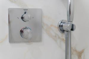 a lightswitch on a wall in a bathroom at Nina da Nazare in Nazaré +43 photos