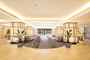 a lobby with couches and potted plants at DoubleTree by Hilton Islantilla Beach Golf Resort in Islantilla