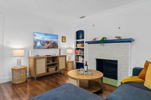 a living room with a couch and a fireplace at Belote Place Bungalow in Jacksonville
