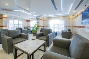 a waiting room with chairs and a table at Al Ayniah Hotel in Medina