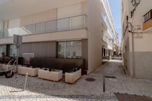 a building with some plants in front of it at Nina da Nazare in Nazaré