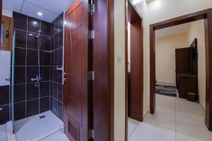 a bathroom with a shower and a glass door at Al Ayniah Hotel in Medina +24 photos