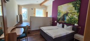 a bedroom with a bed and a painting on the wall at Bel Sole Badenweiler in Badenweiler +37 photos