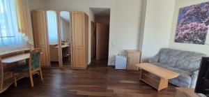 a living room with a couch and a table at Bel Sole Badenweiler in Badenweiler