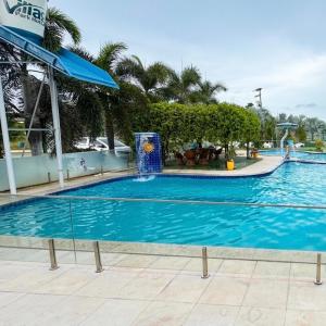 a large blue swimming pool in a resort at Village Park Hotel in Pires Ferreira +2 photos