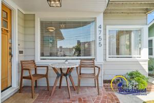 a patio with a table and chairs on a house at Opal Cliff Overlook in Santa Cruz