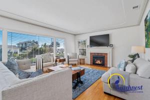 a living room with a couch and a fireplace at Opal Cliff Overlook in Santa Cruz +57 photos