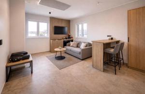 a living room with a couch and a table at Hotel Ks in Bad Fallingbostel