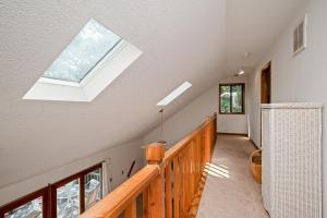 a skylight in a house with a wooden staircase at The Rectory by Oak Island Accommodations in Oak Island