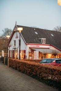 a building with a car parked in front of it at Holiday Home Maridu Tiny Cube in Arnhem