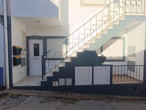 a staircase in a house with white doors at Cantinho da Xica in Lagos