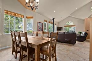 a dining room with a wooden table and chairs at Acanto Del Mar in Aptos +55 photos