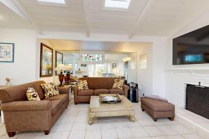 a living room with two couches and a fireplace at Relaxation Station in Corona del Mar