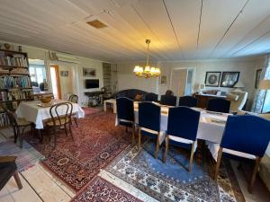 a dining room with a table and chairs in it at Brunnsta Gård in Bålsta