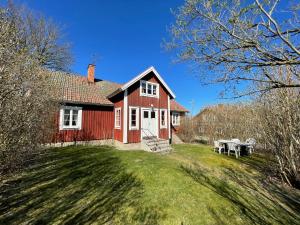 a red house with a picnic table in front of it at Brunnsta Gård in Bålsta