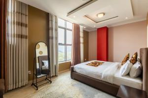 a hotel room with a bed and a television at IZA Serene city centre apartments in Kigali