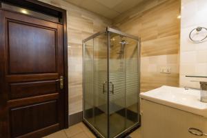 a bathroom with a glass shower and a sink at IZA Serene city centre apartments in Kigali +108 photos