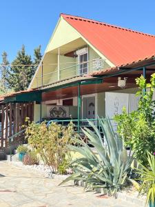 a house with a red roof and some plants at Άνεμος Home 2 in Kavála