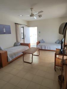 a living room with two beds and a coffee table at Profelia Sea View Apartment in Paralimni
