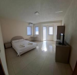 a bedroom with a bed and a flat screen tv at Villa Strmec in Peštani