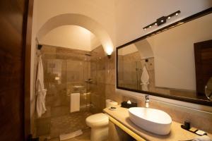 a bathroom with a sink and a toilet and a shower at Mirtala Hotel Boutique in Guanajuato