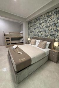 a bedroom with a large bed and a wall mural at Aurea Boutique Rooms in Termoli