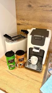 a coffee maker and coffee cups on a counter at Kalkgold Refugium in Kitzingen