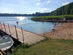a group of people in the water at a beach at Domek Anusia in Brożówka
