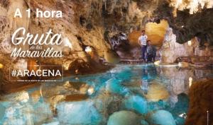 two people standing in a pool of water in a cave at Casa dalia in Moguer