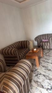 a living room with two couches and a coffee table at Rehoboth place in Awoyaya