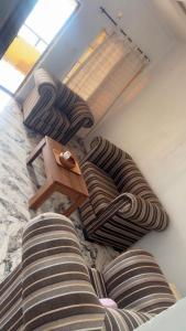 a group of couches in a living room at Rehoboth place in Awoyaya