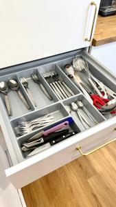 a drawer filled with utensils in a kitchen at Kalkgold Refugium in Kitzingen