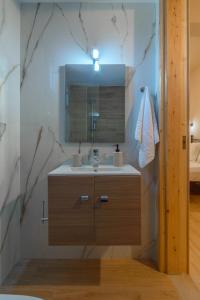 a bathroom with a sink and a mirror at Eudokia's House Platanias in Platanias +35 photos